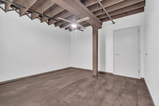 A room with a wooden floor and a white door.
