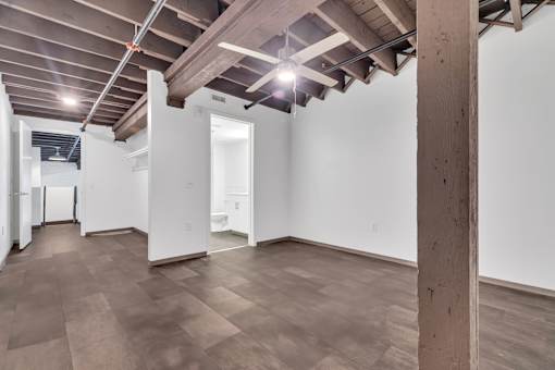 A room with wooden floors and a white wall.