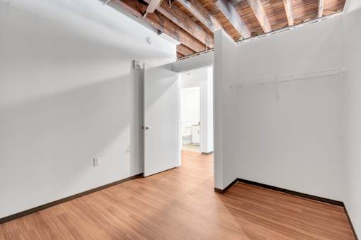 A room with wooden floors and white walls.