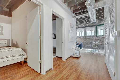 A room with a bed, a chair, and a table.