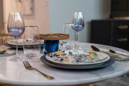A table set with plates, glasses, and cutlery.