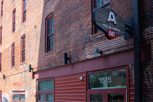 A sign on a building that says 1515 W Ninth East.