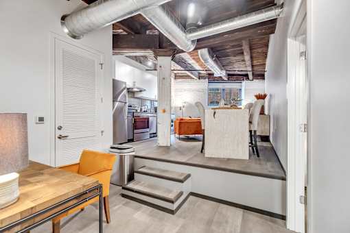 A kitchen with a dining table and chairs is shown.