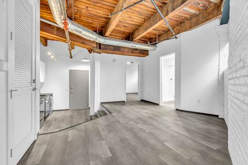 A room with wooden ceiling and white walls.