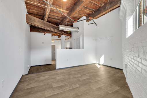 A room with wooden floors and a white wall.