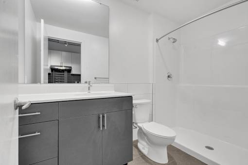 A modern bathroom with a white toilet and a white sink.
