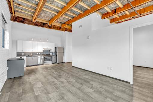 A kitchen with wooden ceiling and grey cabinets.