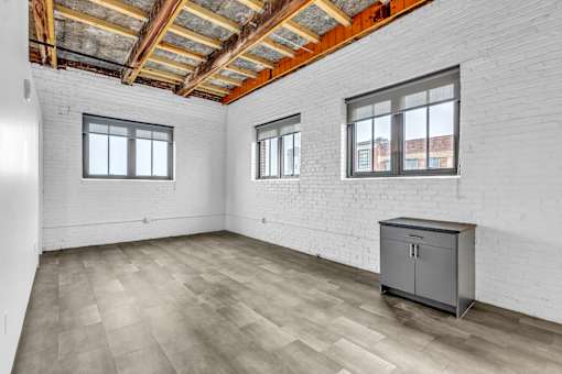 A room with a wooden ceiling and a grey cabinet.
