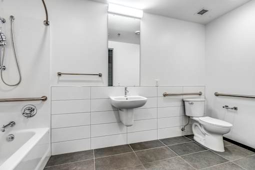 A white bathroom with a sink, toilet, and bathtub.