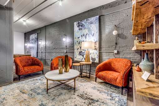A room with a grey wall and a red chair.