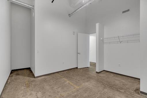 A room with a concrete floor and white walls.