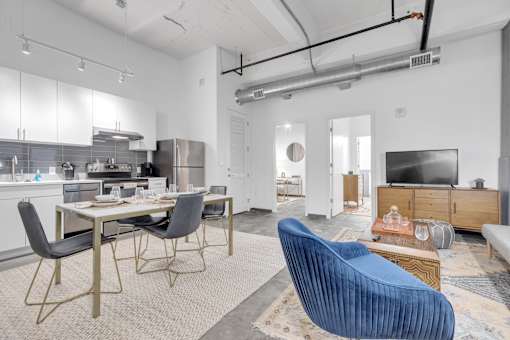 A modern kitchen with a dining table and chairs.