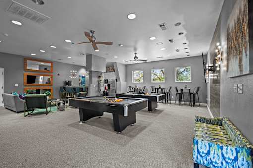 A room with a pool table and a couch.