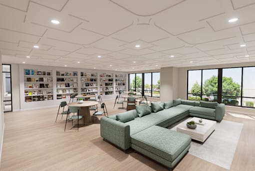 A modern living room with a green sofa set and a bookshelf filled with books.