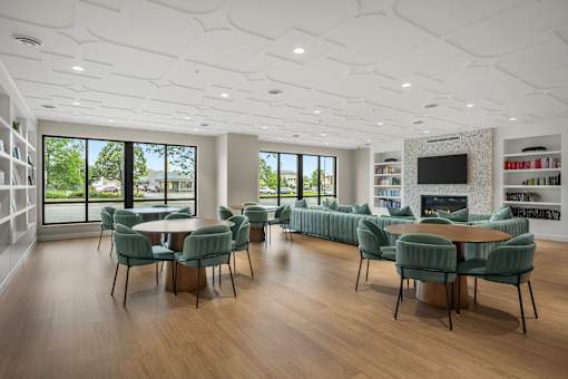 A modern living room with a large table and chairs.