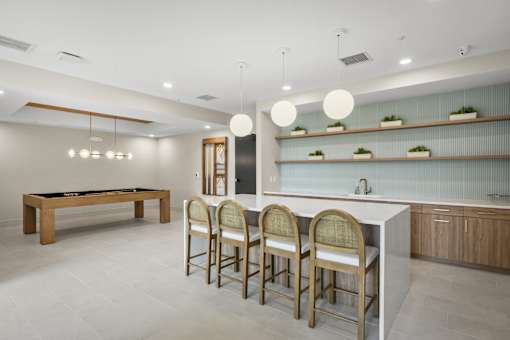 A modern kitchen with a pool table.