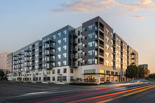 A modern apartment building with a street in front of it.