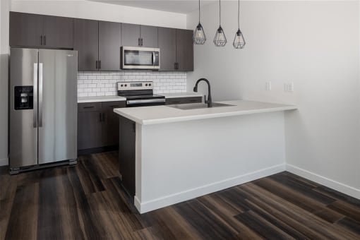 a kitchen with a large island and stainless steel appliances at The Landing at 1001 NP, Fargo, North Dakota 58102