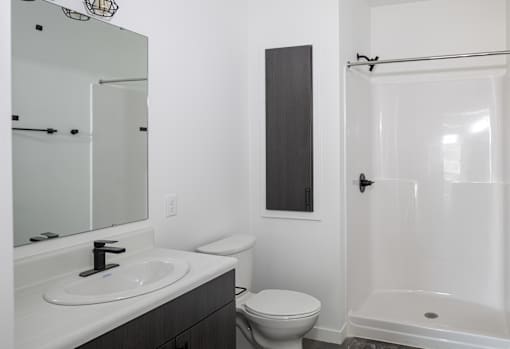 Modern bathroom with walk in shower at The Avery - Residential Apartments, Fargo, 58102