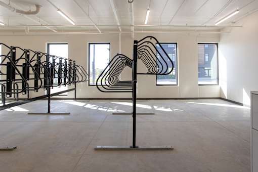 Bike storage rack in modern indoor space at The Avery - Residential Apartments, North Dakota, 58102