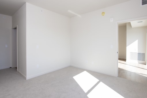an empty living room with white walls and carpet at Riverhouse Apartments, North Dakota