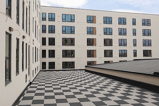 Courtyard with checkered tile flooring and building facade at The Avery - Residential Apartments, Fargo, North Dakota