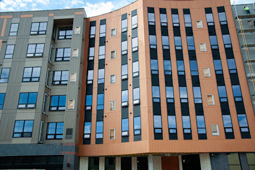 Modern apartment building exterior with vertical design at The Avery - Residential Apartments, North Dakota