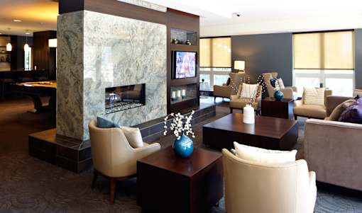 A living room with a fireplace and a TV.