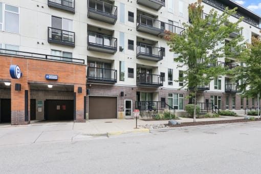 an empty parking lot in front of an apartment building