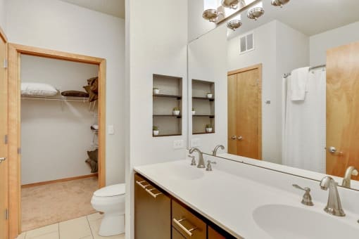 a bathroom with a sink and a toilet and a mirror
