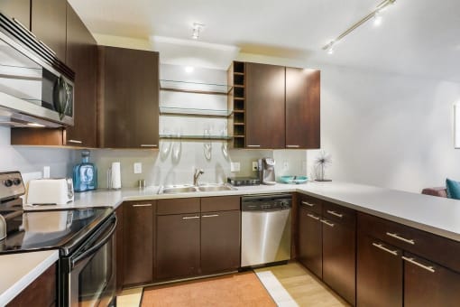 a kitchen with wooden cabinets and stainless steel appliances
