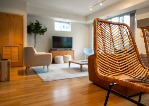 a living room with a wooden chair in front of a television