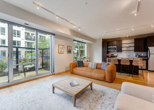 a living room with a couch and a coffee table in front of a large window