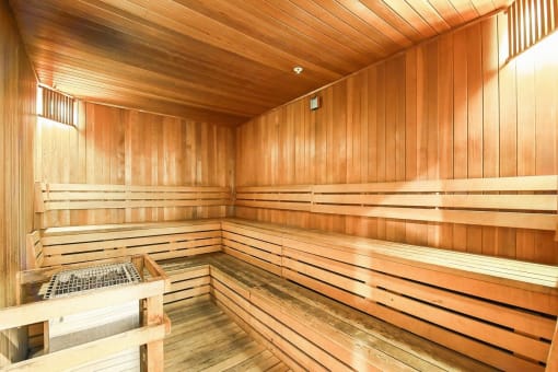 a sauna in a wooden room with wooden walls and a table