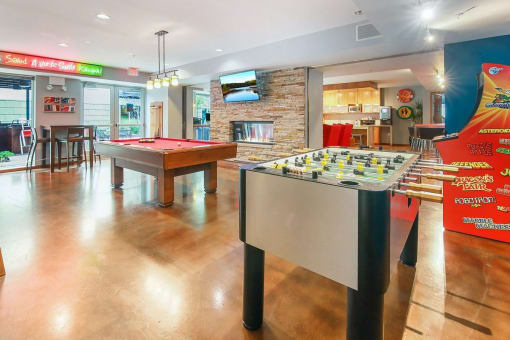 two pool tables in a game room with a bar