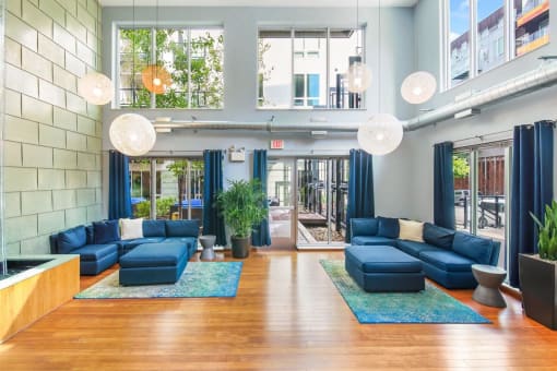 the lobby of a building with blue couches and blue rugs