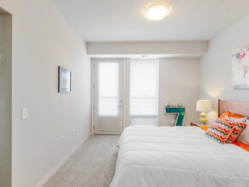 a bedroom with a bed and a door to a bathroom