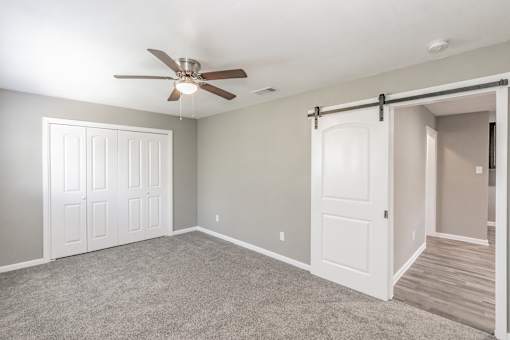 Bedroom with ceiling fan and neutral tones at Chapel Creek Apartments Dallas