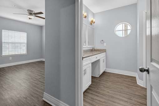 A room with a window, a fan, and a counter.