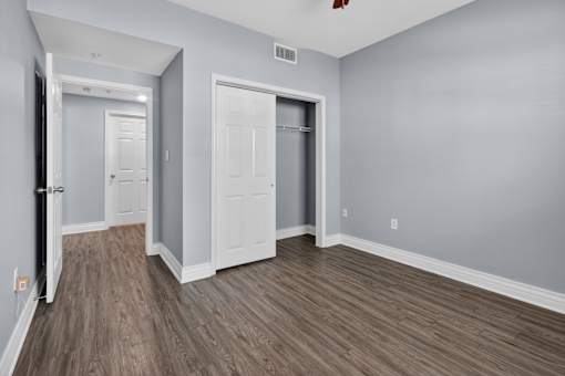 A room with two doors and a wooden floor.