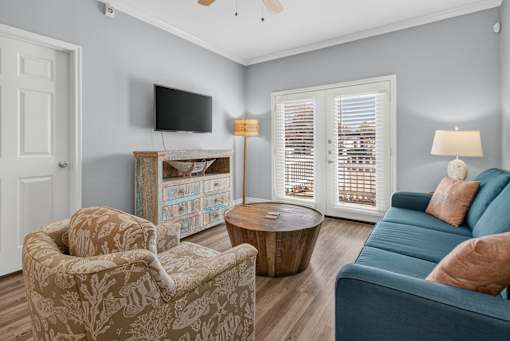 A living room with a blue couch and a television.