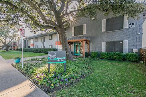 Chapel Creek Apartments exterior with landscaped walkways in Dallas