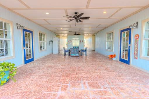 A long hallway with a fan and chairs.