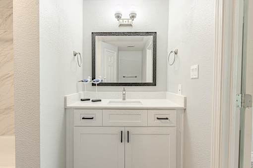 A bathroom vanity with a mirror above it.