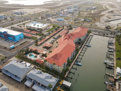 an aerial view of a city with a body of water and buildings