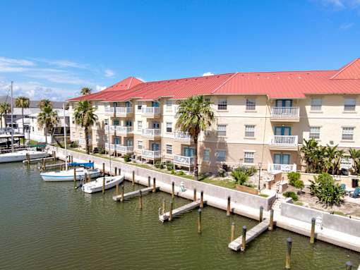 A marina with boats and a building with a red roof.