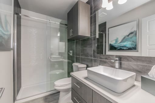 Modern bathroom with sleek tile design and large vanity at Reserve on Abrams