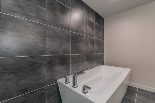 Large soaking tub and tile surround in luxury bathroom at Reserve on Abrams