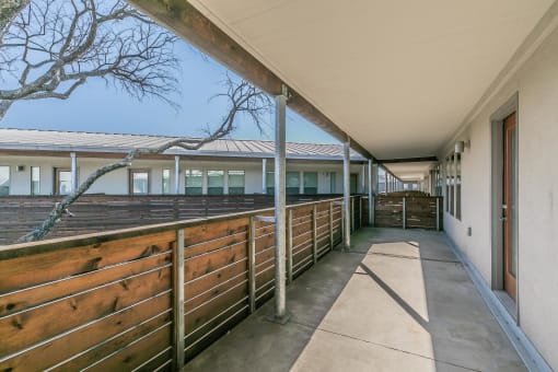 Private patio with wood railing overlooking courtyard at Reserve on Abrams