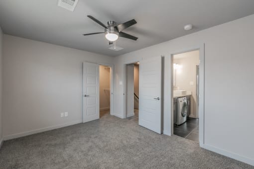 Stylish bedroom with ceiling fan and natural light at Reserve on Abrams Dallas